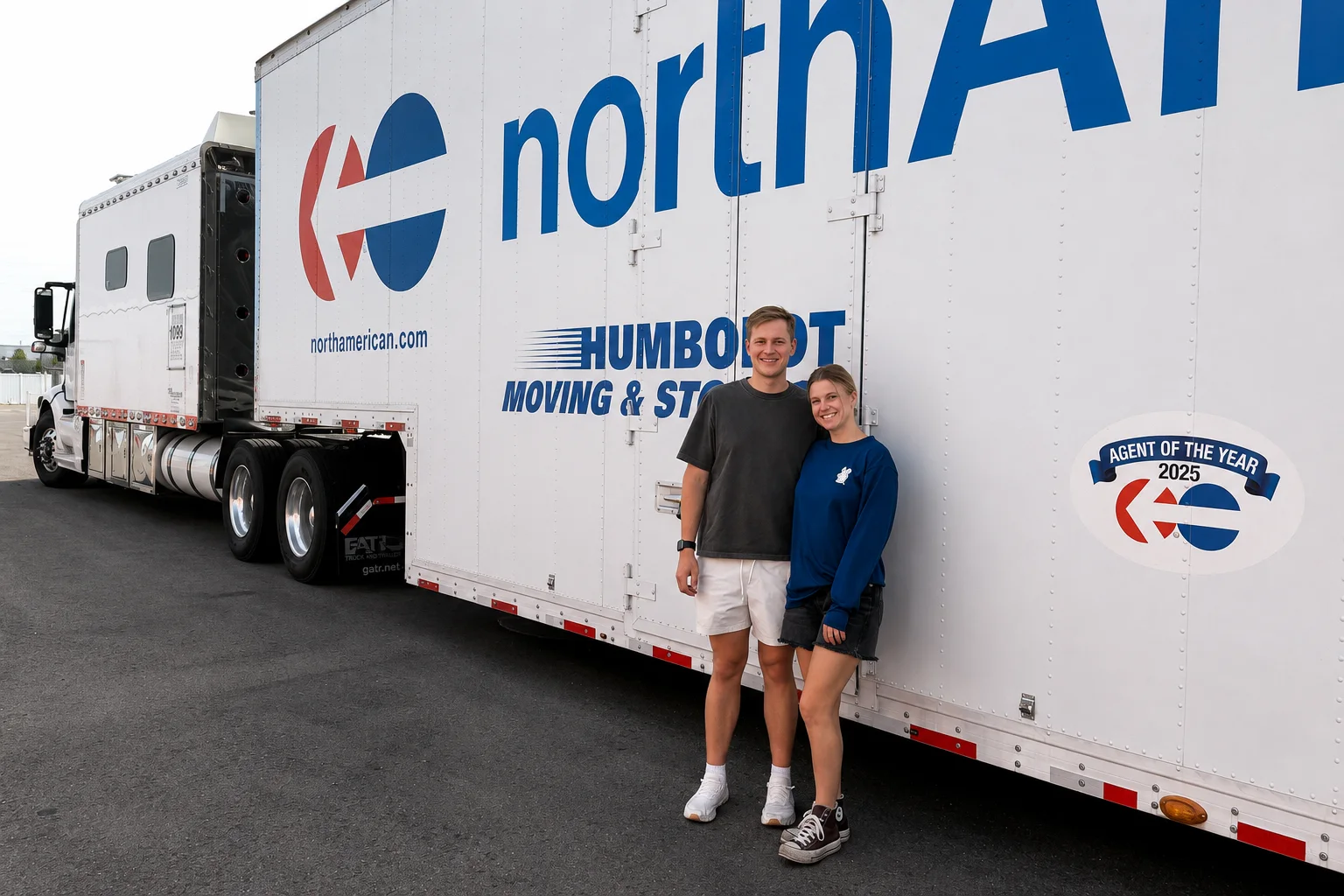 Two customers beside a Humboldt Moving & Storage truck after an interstate move.