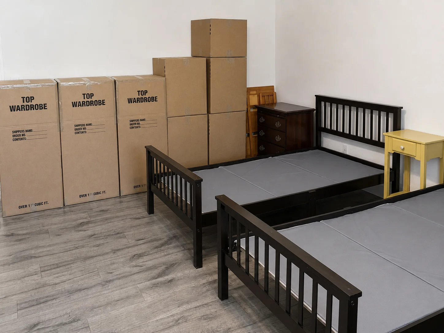Wardrobe boxes and bedroom furniture prepared for a household move.